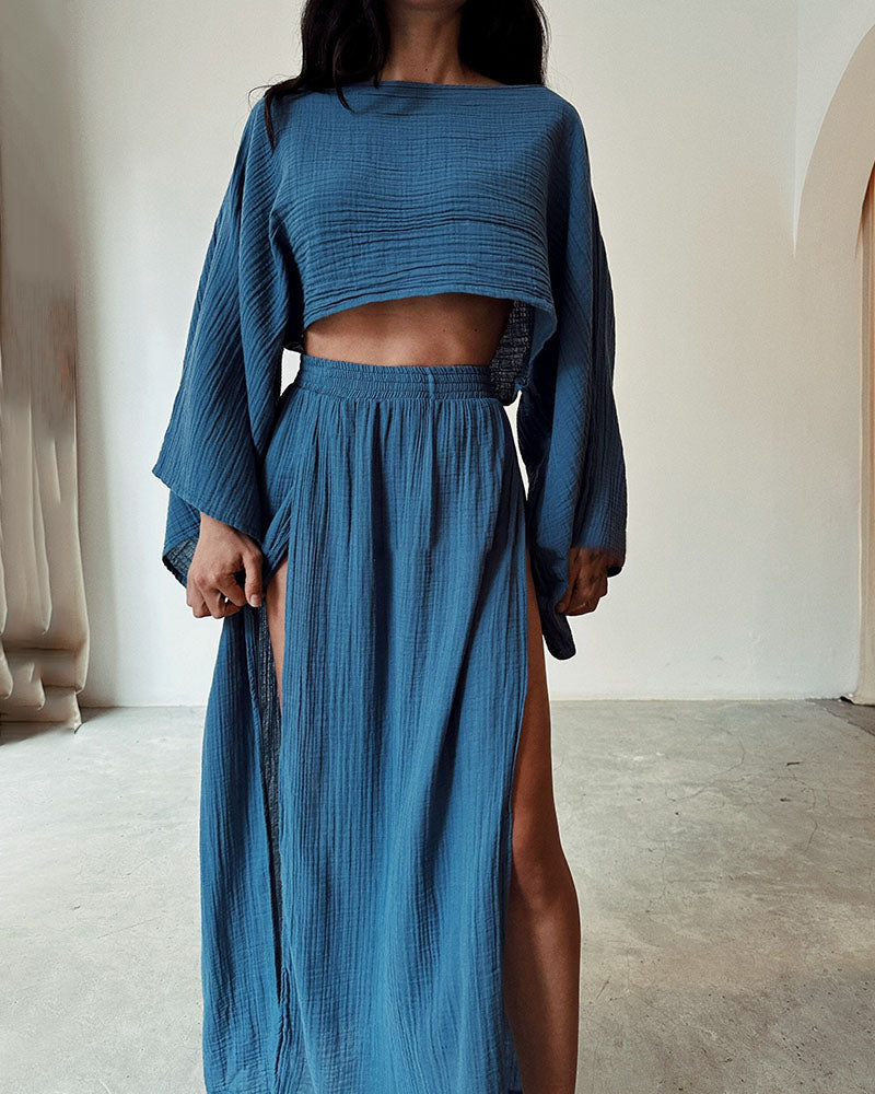 Coordinated women's long sleeve crop top & side split maxi skirt ensemble. Stylish two-piece for versatile fashion.