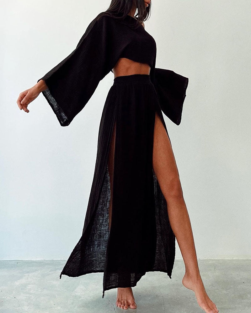 Fashionable women's crop top and side split maxi skirt set. Elegant long sleeve two-piece for spring/summer style.