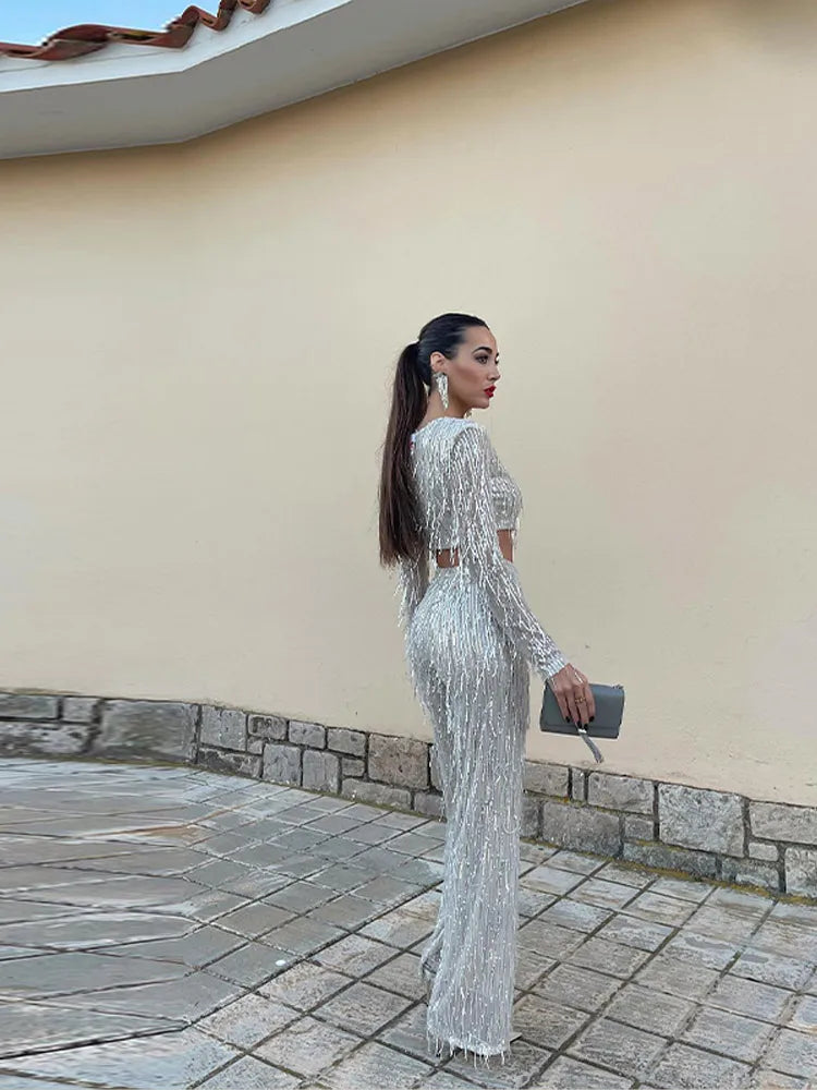 Elegant women's sequin two-piece set featuring a sparkling top and comfortable high-waist trousers.