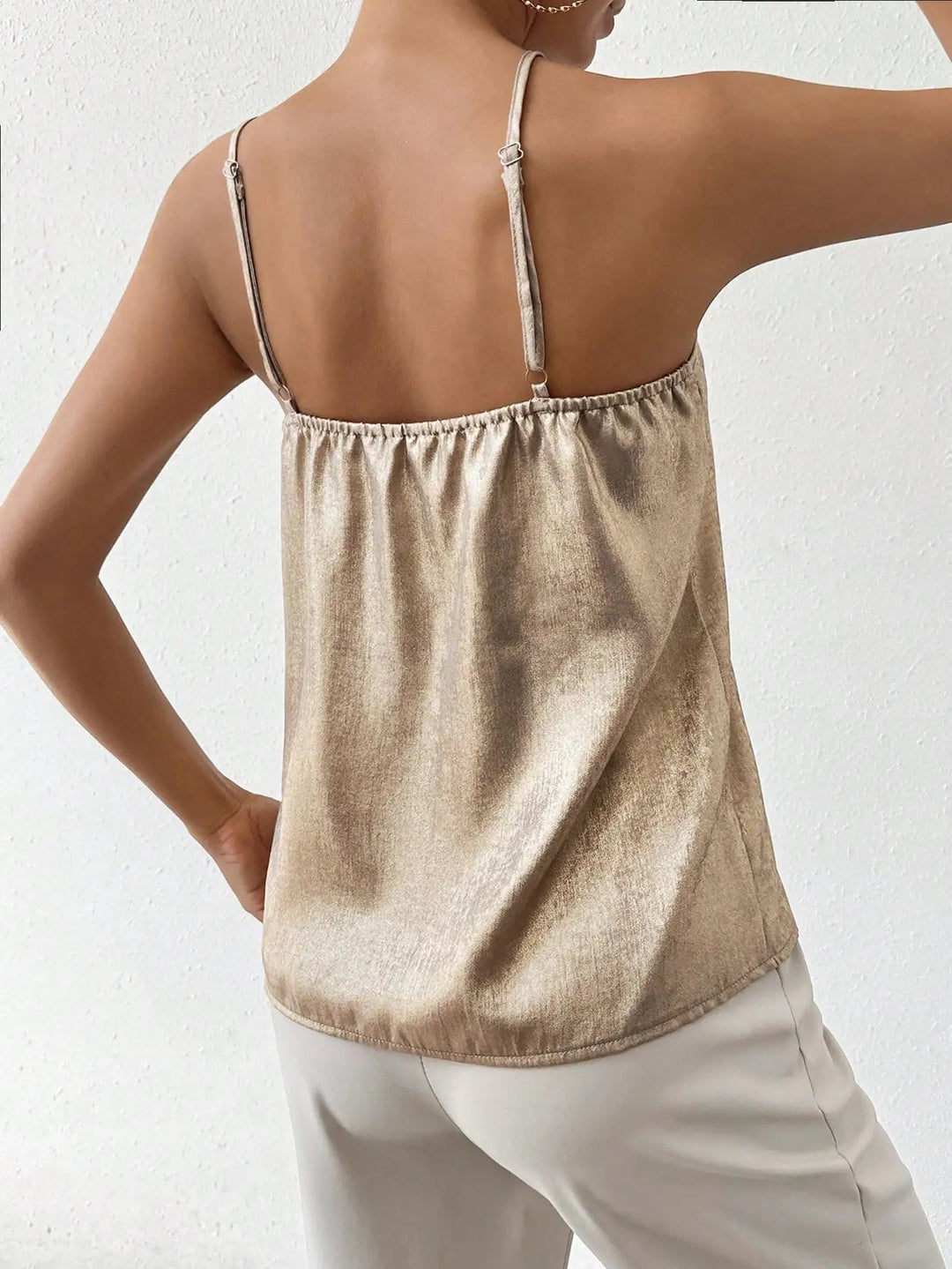 Chic sleeveless V-neck shimmer cami for women, featuring adjustable straps and an elegant design.