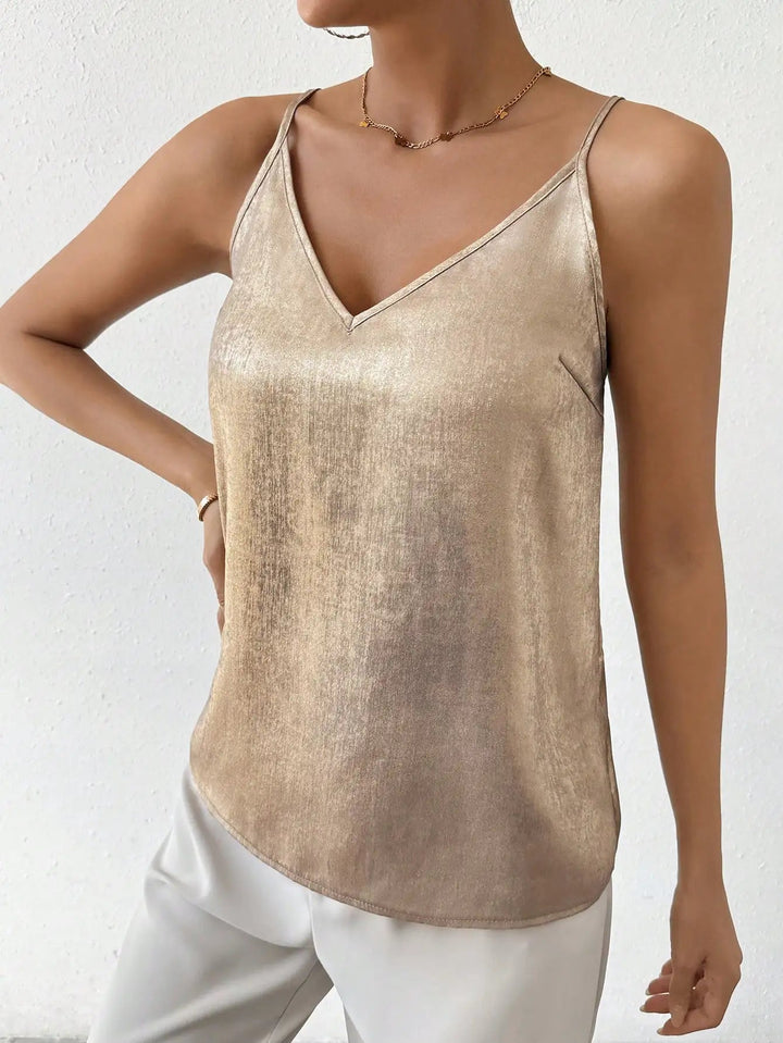 Close-up of a shimmering gold V-neck cami top for women, highlighting its elegant fabric and straps.