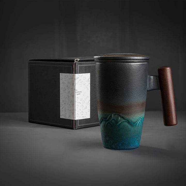 Artistic blue handmade ceramic tea mug with strainer for loose tea; retro design, comfortable.