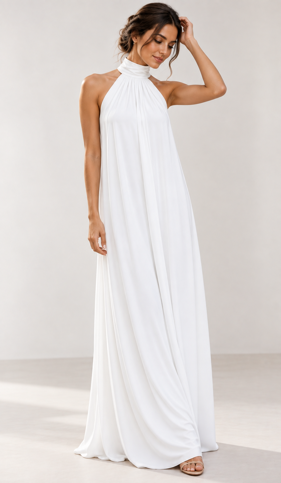 Sophisticated white halter neck maxi dress for women. Elegant formal wear, evening gown, or chic wedding guest dress.