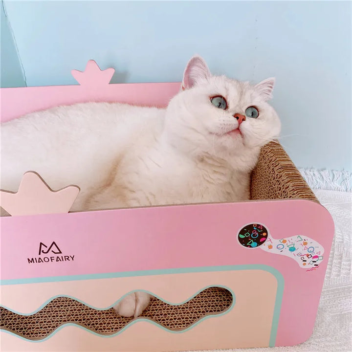 Pink cat scratching box with durable scratch board and interactive play toy for feline fun and comfort.