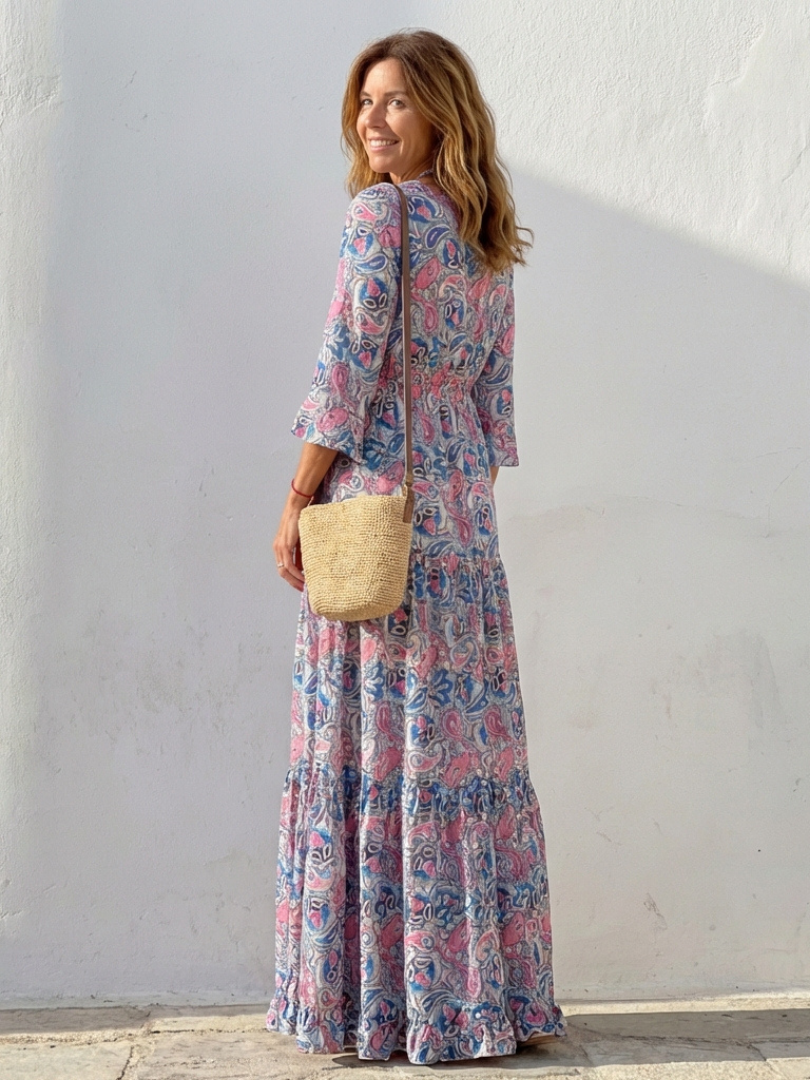Flowy paisley print bohemian maxi dress for women, featuring a V-neck and long sleeves, ideal for travel.