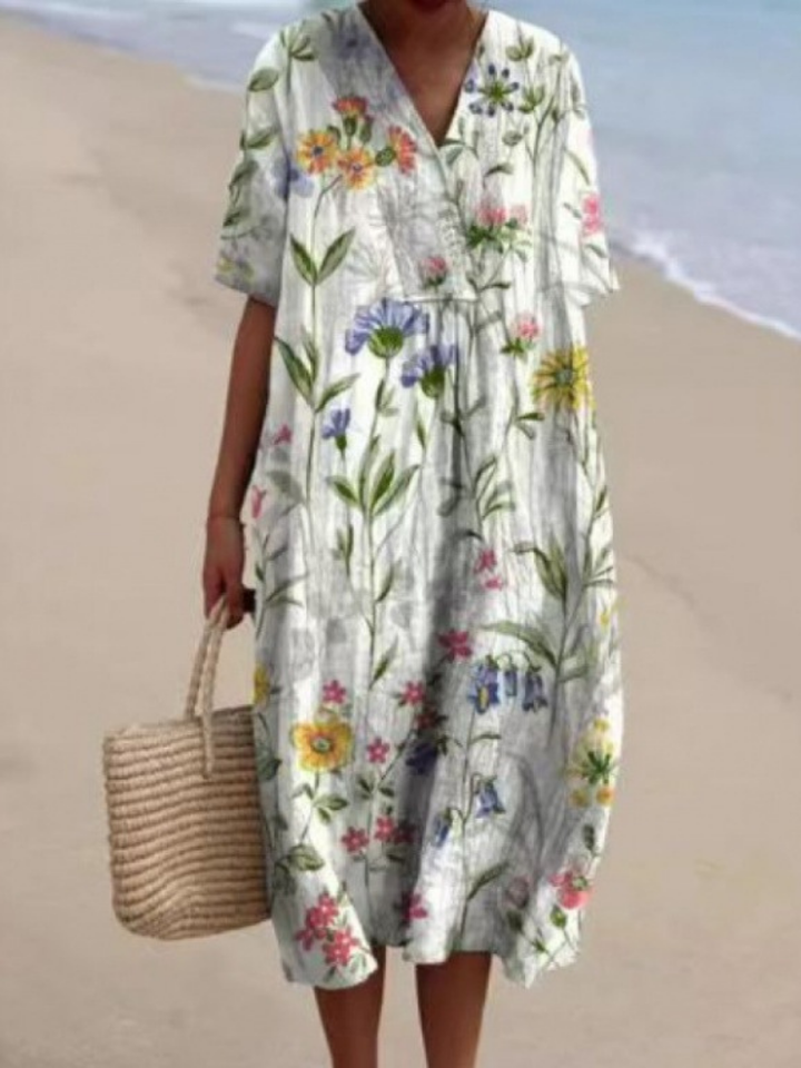 Elegant women's short sleeve floral midi dress, relaxed and breezy, suitable for warm weather.