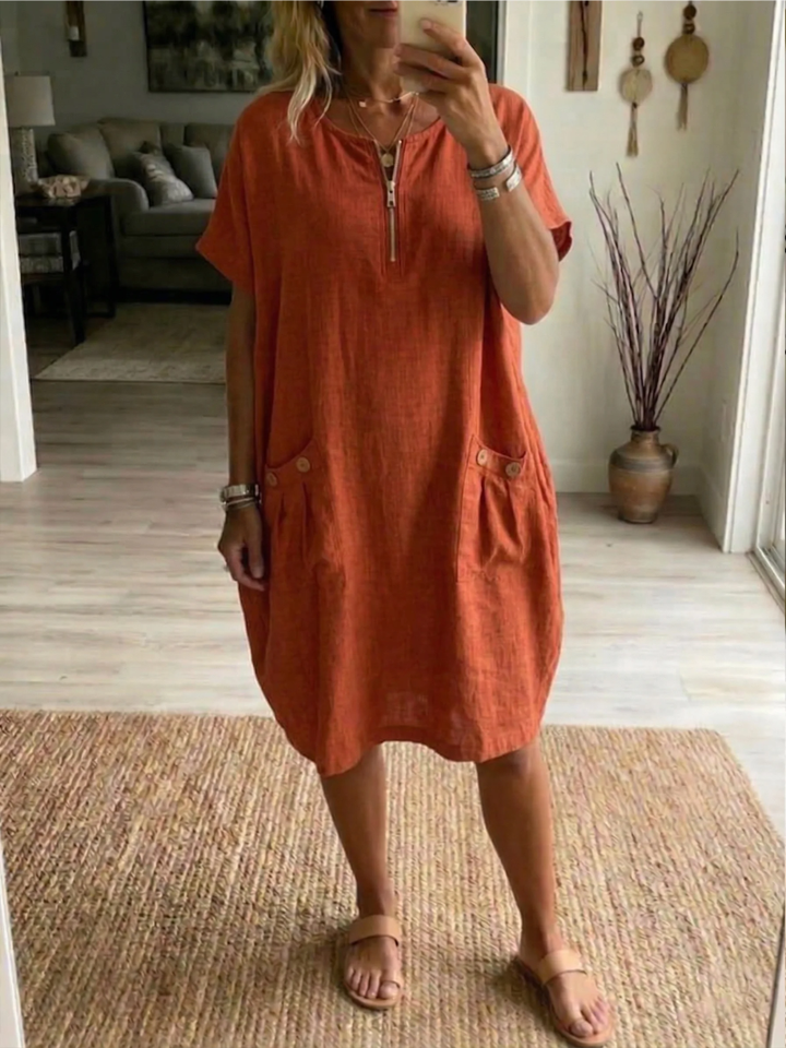 Blue women's relaxed fit summer dress featuring a zip-front, V-neck, and pockets for casual style.