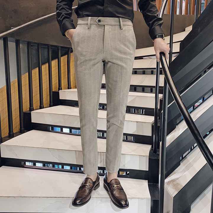 Modern men's slim-fit dress pants with a subtle herringbone pattern, ideal for a sophisticated formal or smart casual outfit.