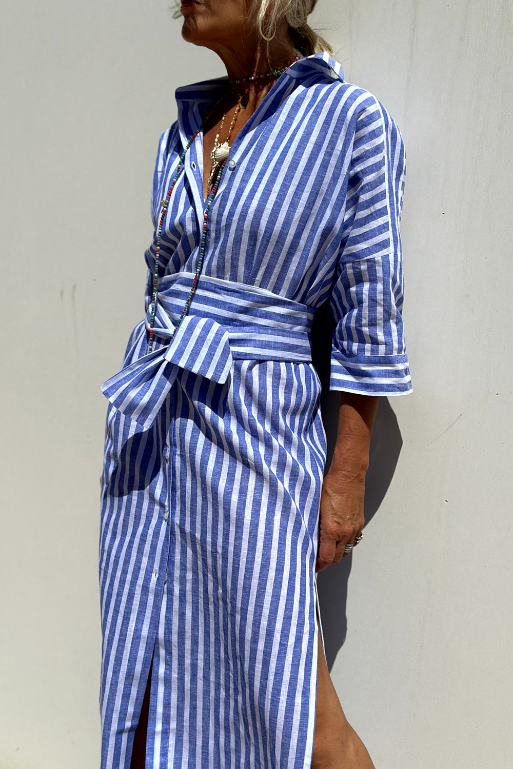 Effortless women's striped shirt dress for summer comfort. Stylish casual day dress, versatile beachwear.