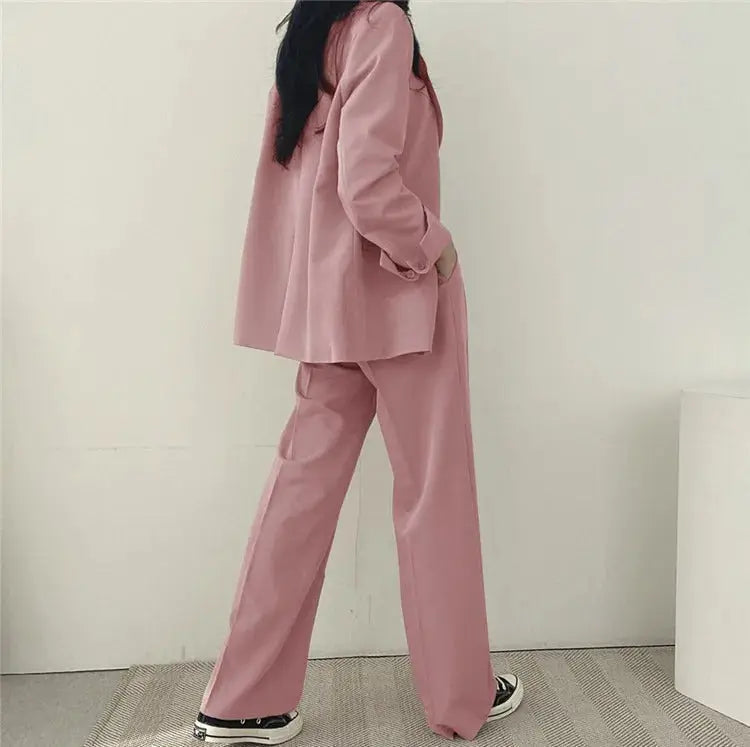 Modern women's business attire, a chic tailored blazer and matching trousers.