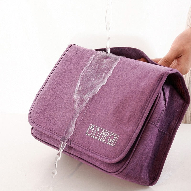 Open deluxe hanging toiletry bag showing organized compartments for travel & personal care items.
