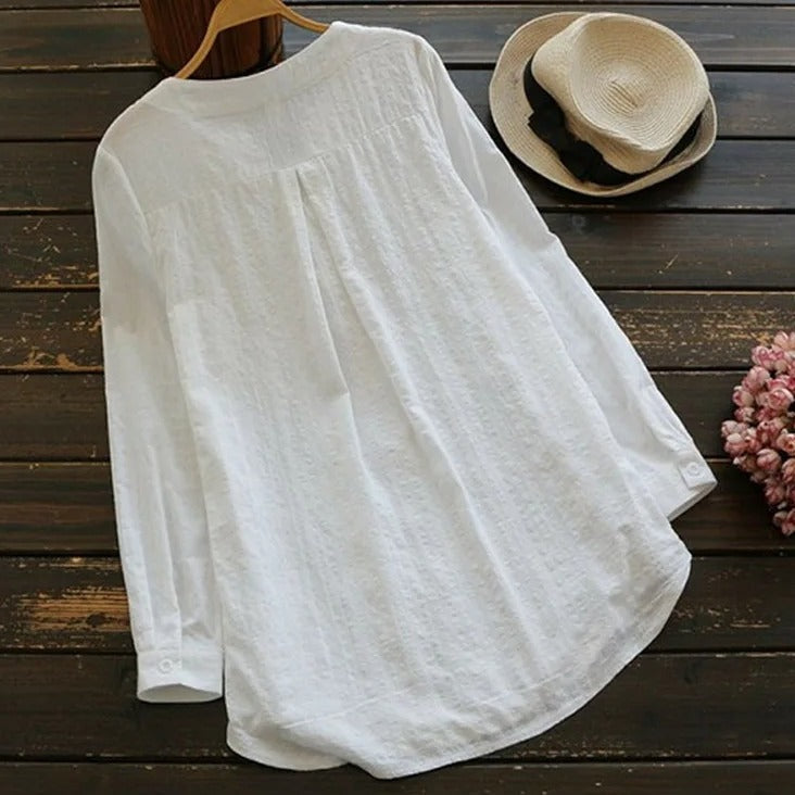 Elegant white long-sleeved top for women, perfect for versatile everyday casual or chic styling. Comfortable all-season.