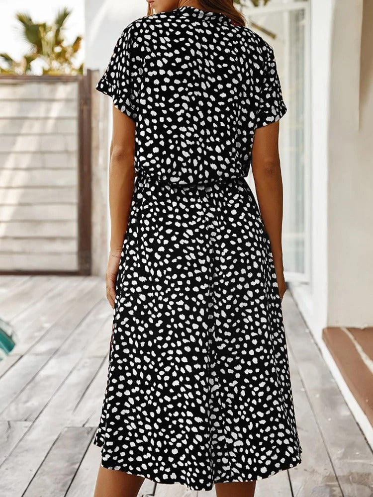 Chic women's summer midi dress, elegant & lightweight, offering a flattering, casual look.