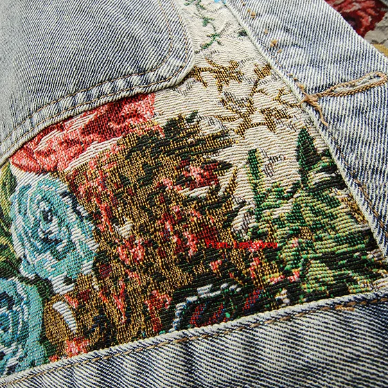 Classic women's denim jacket reimagined with modern hand-painted floral art. Unique boho chic outerwear.