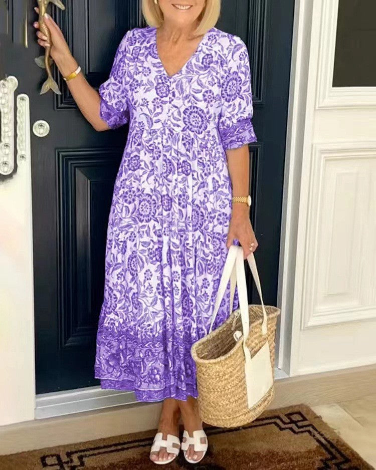 Elegant women's V-neck maxi dress with a vibrant print and flowy silhouette.