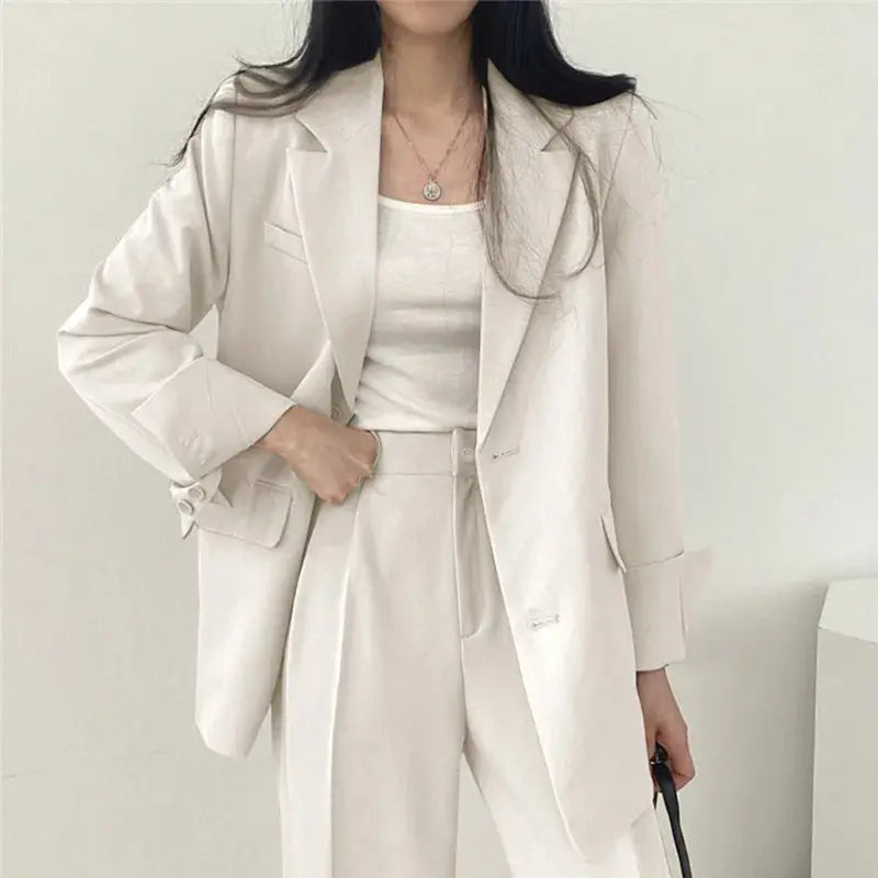 Sleek women's office wear: elegant tailored blazer & comfortable trouser set.