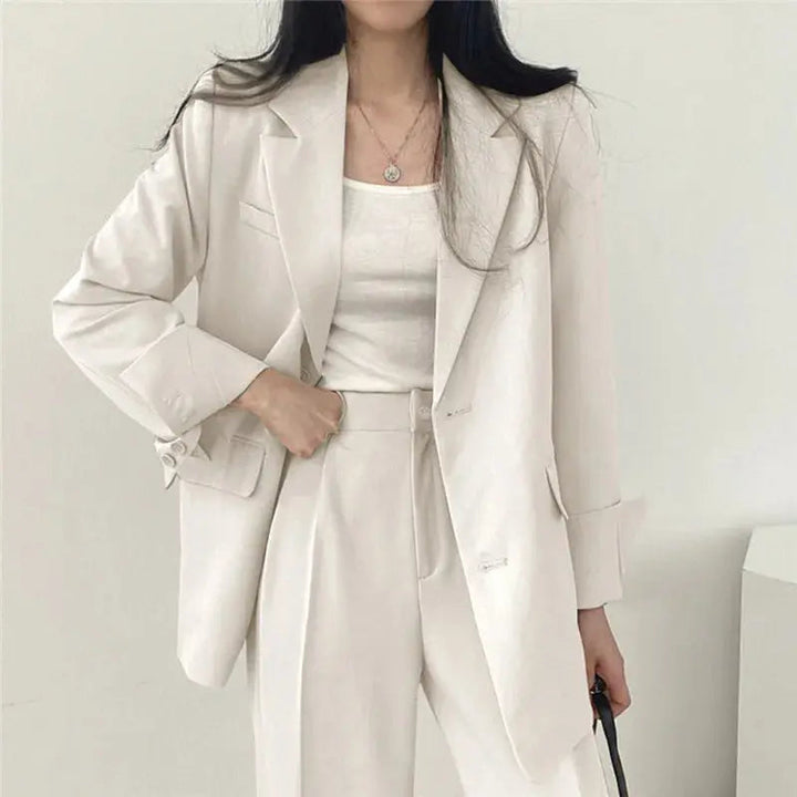 Sleek women's office wear: elegant tailored blazer & comfortable trouser set.