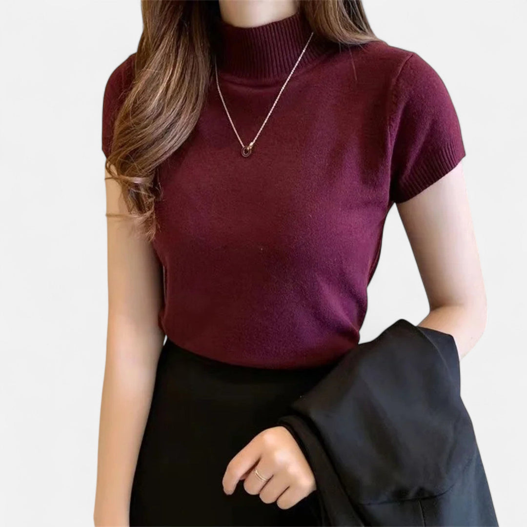 Casual yet elegant women's knitted short-sleeve turtleneck blouse, perfect for versatile sophisticated comfort.