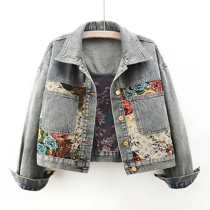 High-quality women's denim jacket showcasing beautiful hand-painted floral designs. Unique and fashionable.
