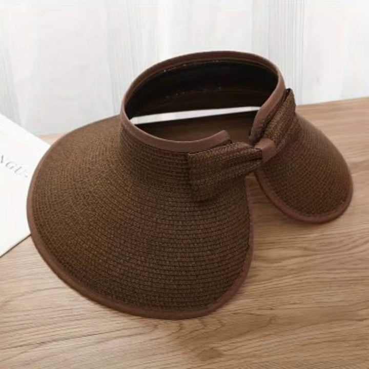 Adjustable women's straw wide brim visor, UPF 50 sun protection beach hat, essential summer travel accessory.