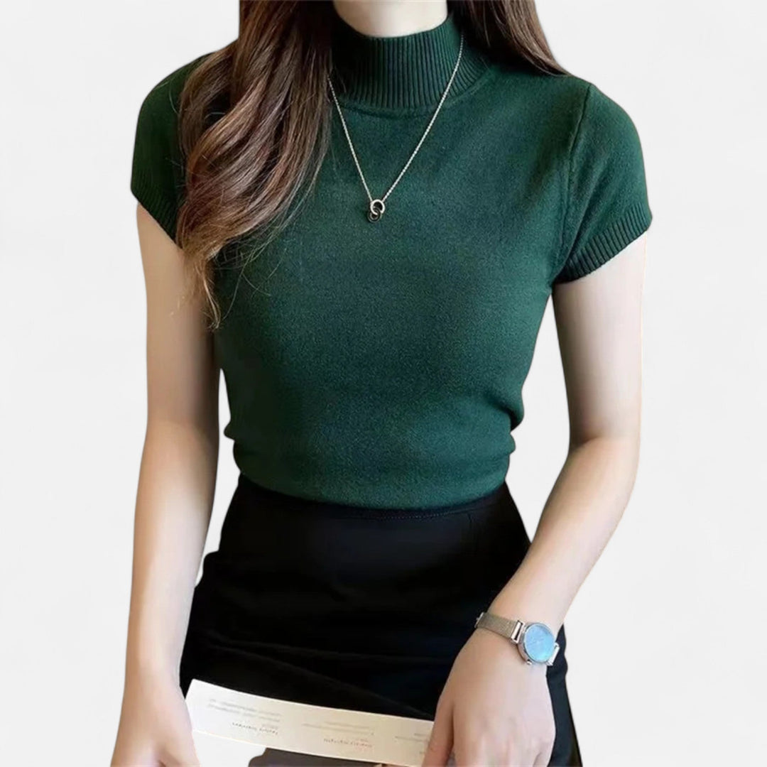 Elegant women's knitted turtleneck blouse with short sleeves, perfect for sophisticated style.