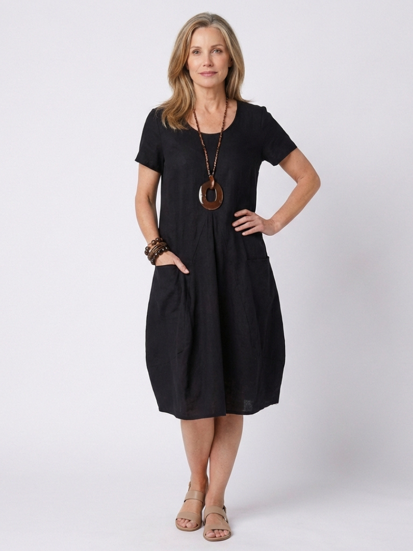 Effortless & elegant women's short sleeve pleated knee-length dress. Relaxed fit, perfect for casual summer fashion.