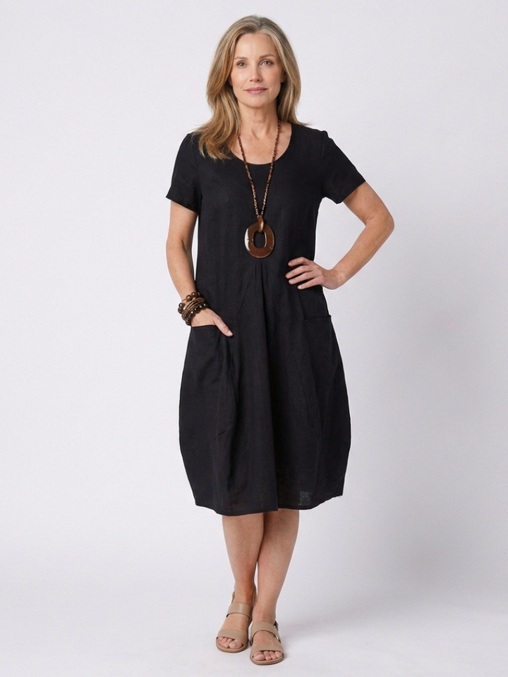 Effortless & elegant women's short sleeve pleated knee-length dress. Relaxed fit, perfect for casual summer fashion.