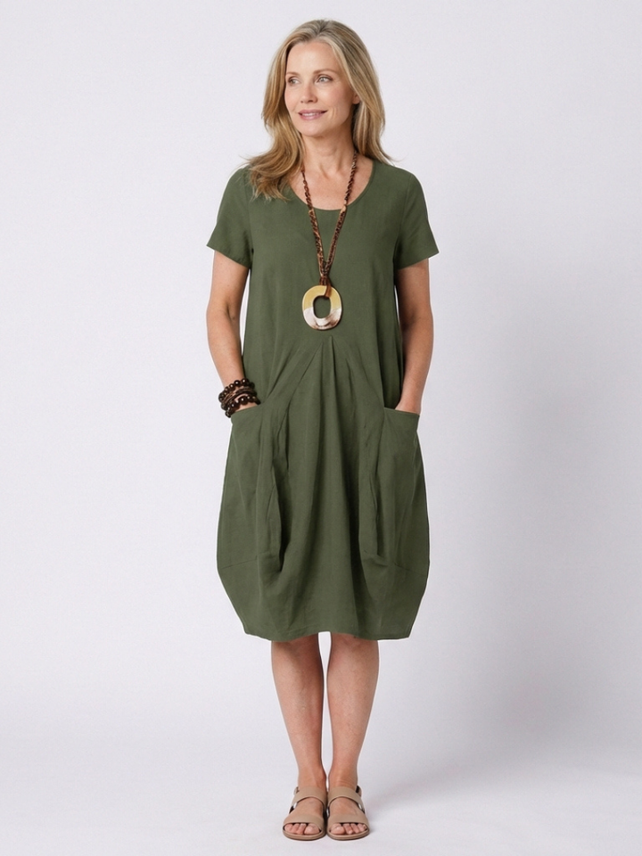 Versatile women's short sleeve pleated knee-length dress. Comfortable, elegant, and perfect for everyday summer fashion.