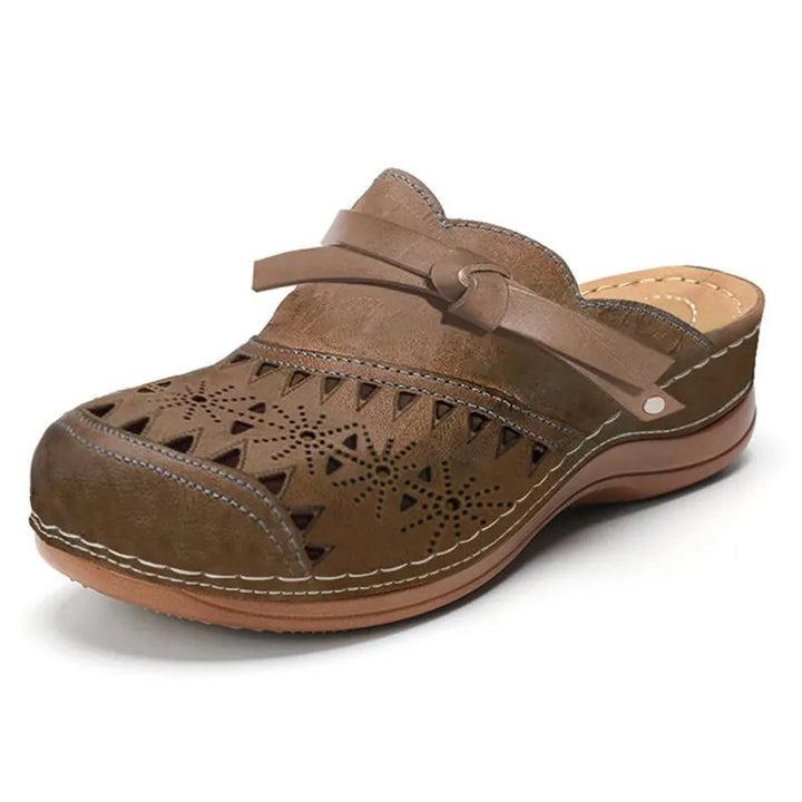 Casual women's orthopedic mule clogs, perforated for breathability, offering arch support & comfort for work.
