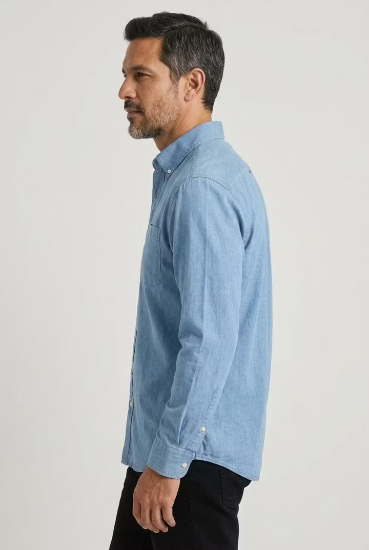 Relaxed fit men's button-up chambray shirt. Long sleeve design for comfort and everyday versatility.
