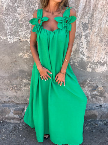 Women's flowing maxi dress with bow straps & U-neck, capturing its elegant movement for summer parties.