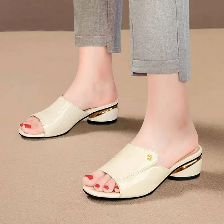 Stylish women's comfort slides, glossy footwear for summer style, offering an elegant open-toe look.