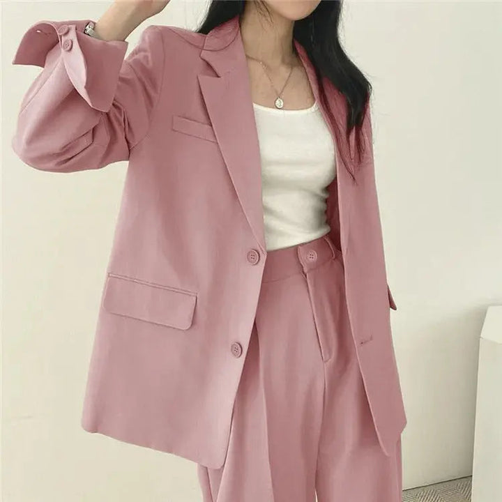 Stylish women's blazer and trouser set, ideal for smart casual or formal events.