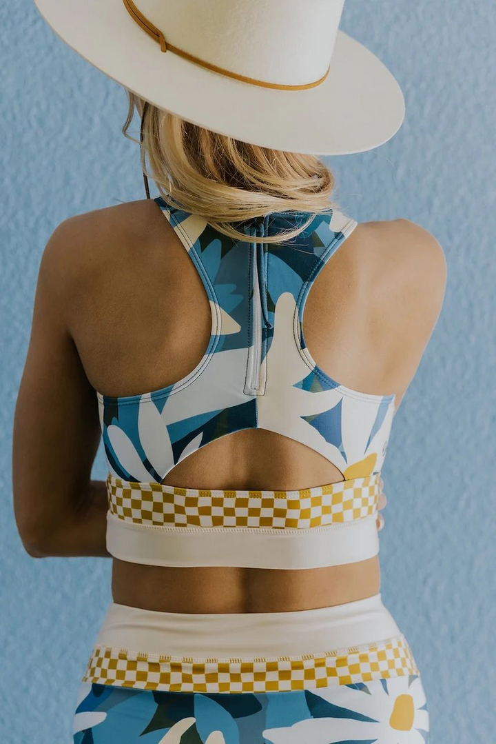 Women's stylish striped swimwear with a modern zip-back design, ideal for the beach.