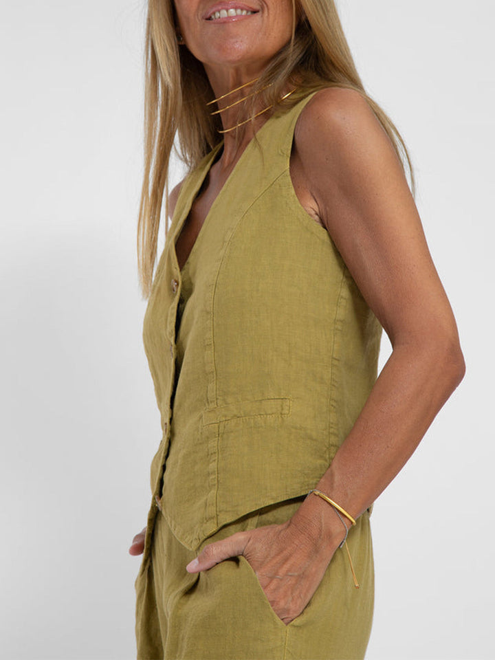 Front view of a woman wearing the versatile sleeveless V-neck top and wide-leg trouser set.