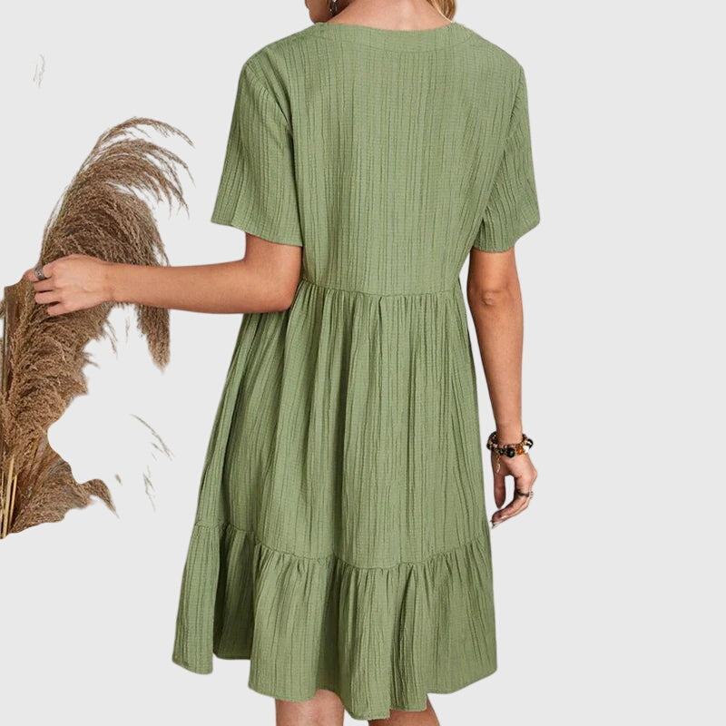 Stylish women's midi dress with short sleeves. Elegant and flattering silhouette, perfect for a chic casual or party look.