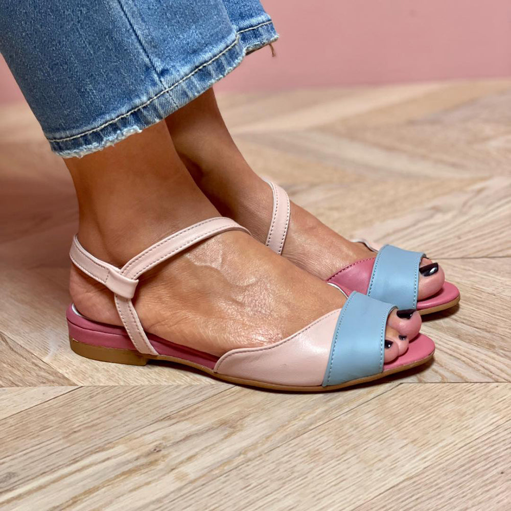 Chic women's pink asymmetrical summer sandals with a comfortable low heel, perfect for elegant everyday wear.