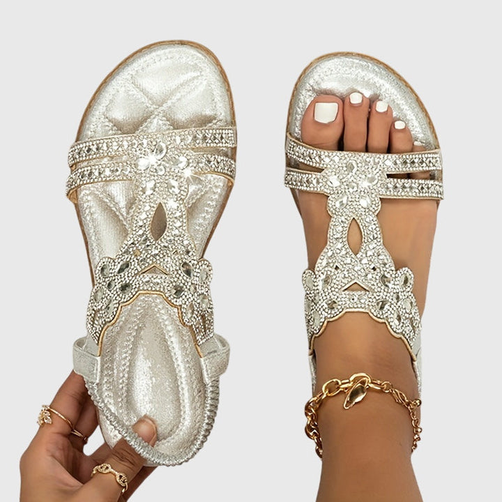 Pain relief women's sandals featuring a supportive back strap & cushioned footbed.