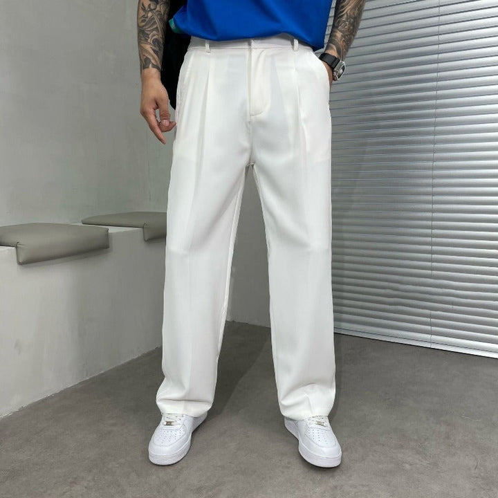 Stylish man wearing men's wide-leg dress trousers with double pleats, showcasing a modern, comfortable fit for all-season fashion.