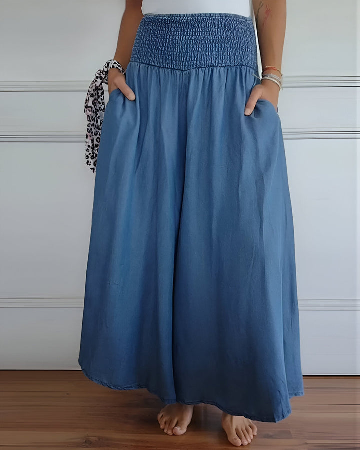 Women's flowy smocked maxi skirt with practical side pockets. Perfect for summer and spring style.