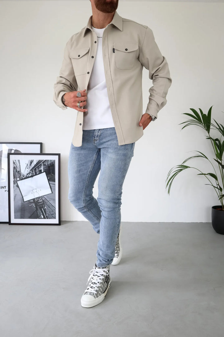 Chic women's water-resistant button-down shirt jacket with long sleeves. Modern casual outerwear for layering.