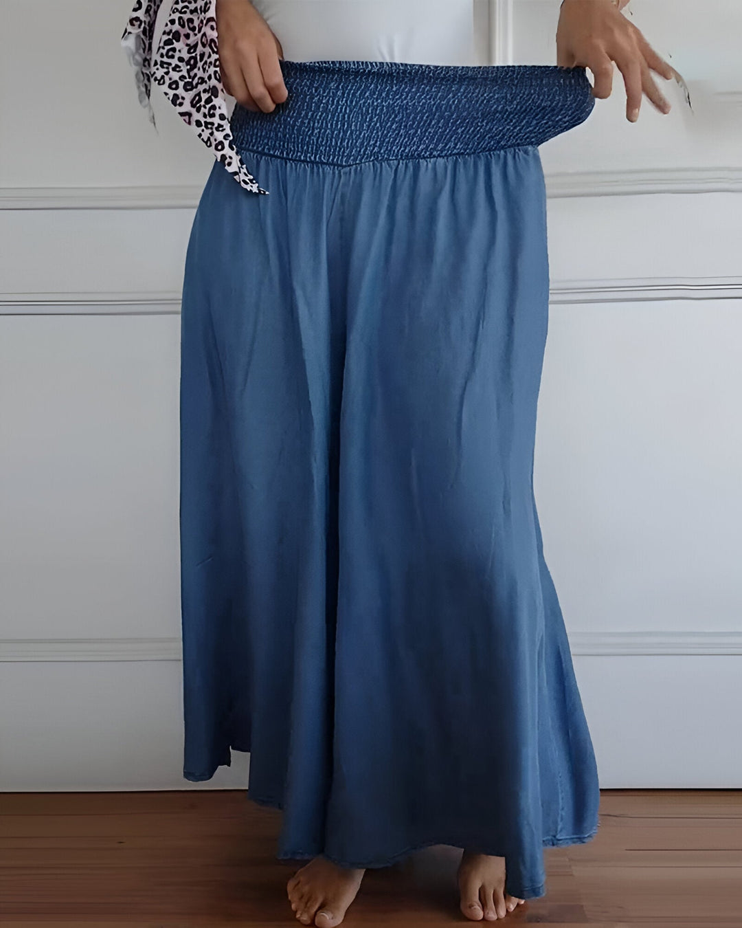 Comfortable women's long maxi skirt. Features an elegant smocked waist & convenient pockets for casual wear.