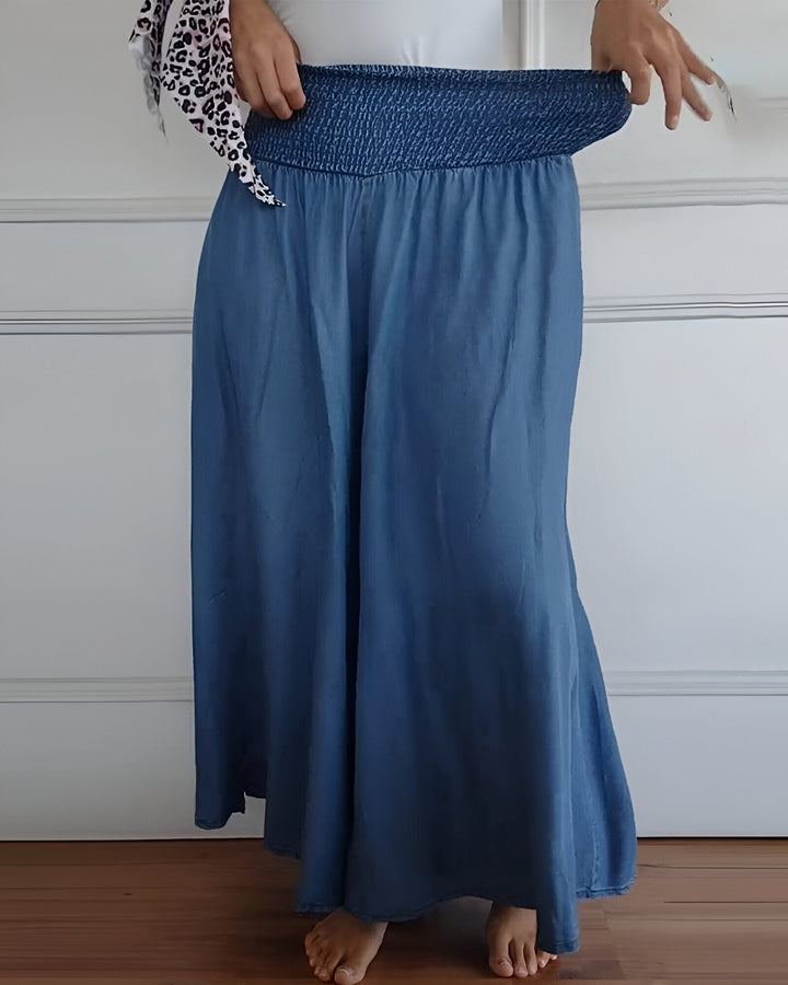 Comfortable women's long maxi skirt. Features an elegant smocked waist & convenient pockets for casual wear.