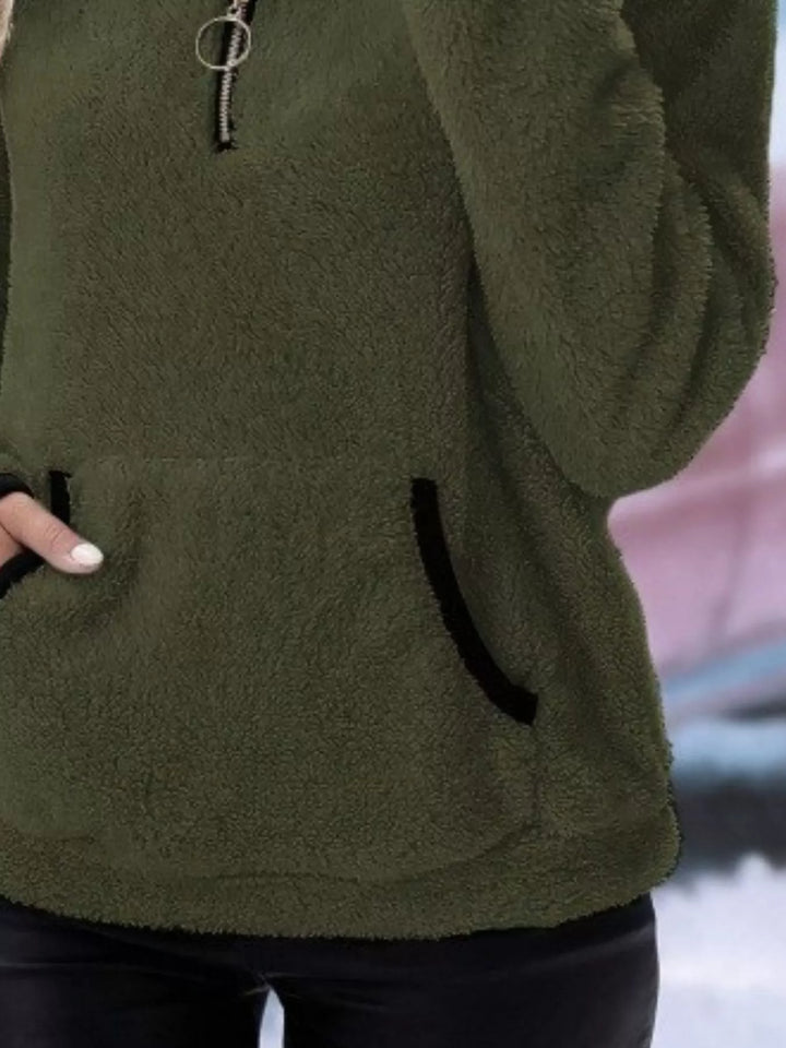 Warm women's half-zip pullover, offering cozy comfort in a relaxed fit.