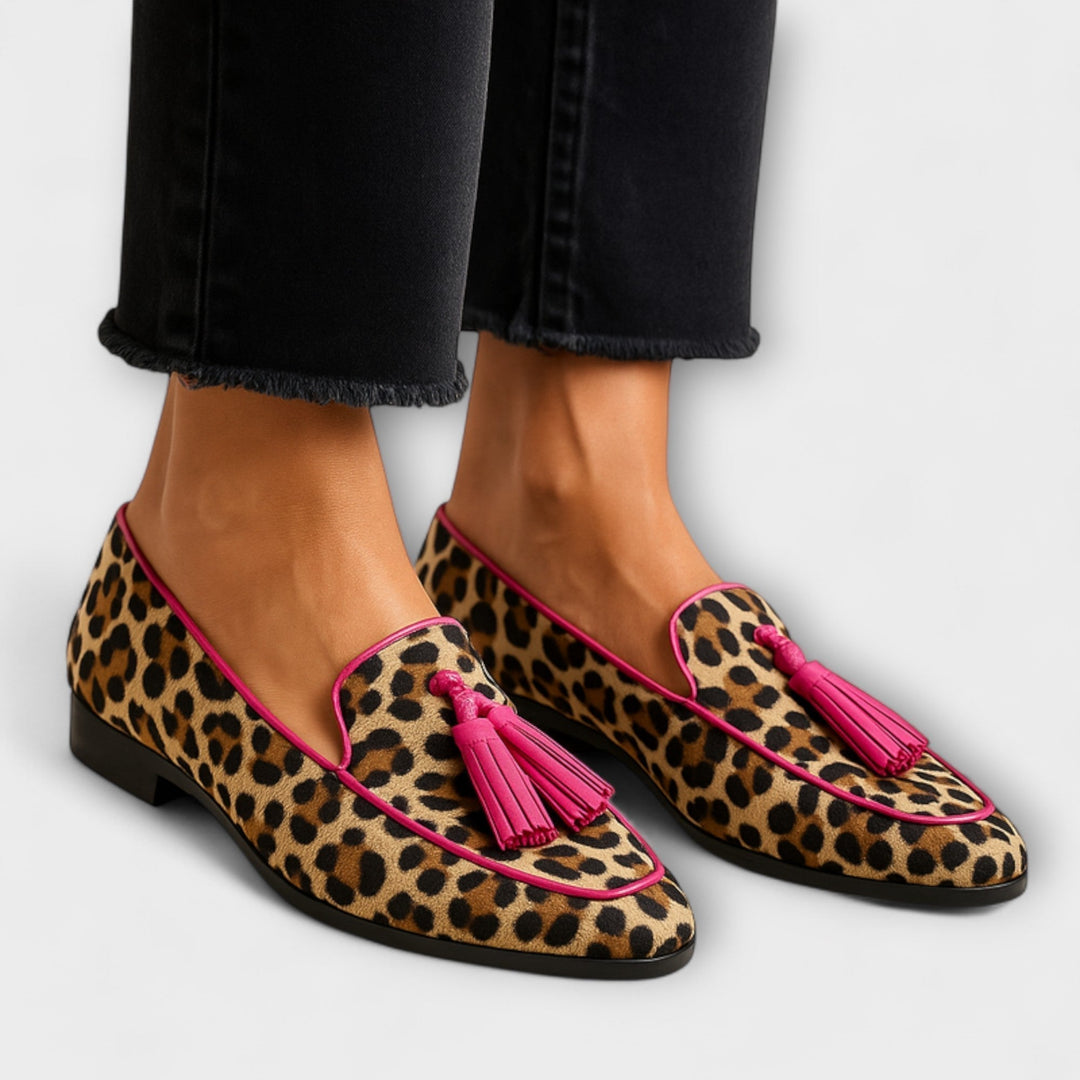 Women's animal print slip-on loafers with playful tassels, offering casual comfort and vibrant fashion style.