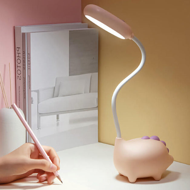 Eco-friendly T-Rex LED desk light for kids; whimsical dino shape, adjustable neck, soft eye-caring light; available in yellow