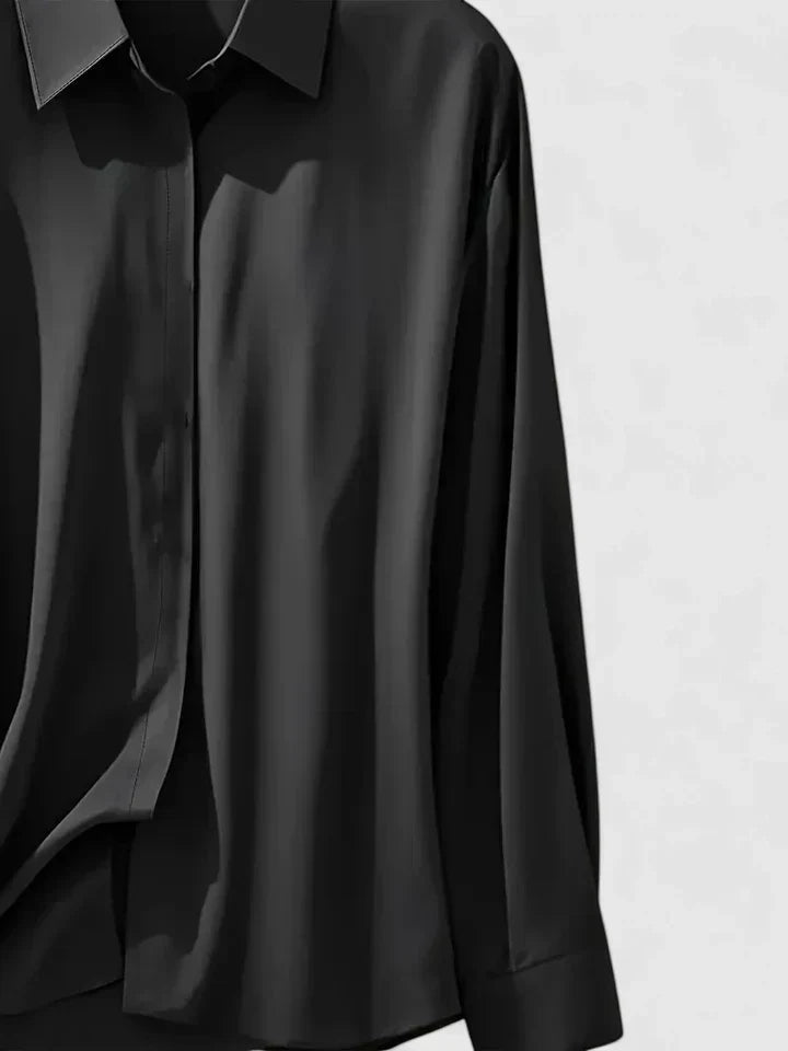 Professional & casual women's elegant button-down blouse. Versatile long sleeve top with a curved hem.