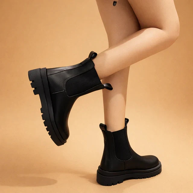 Elegant black women's high slip-on boots for effortless style, comfort, and versatile fall/winter fashion.