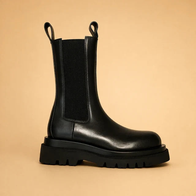 Women's comfortable high slip-on boots. Perfect black footwear for elegant casual winter and fall outfits.