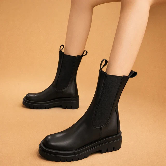 Stylish women's black high slip-on boots. Designed for elegance, comfort, and easy wear for fall & winter.